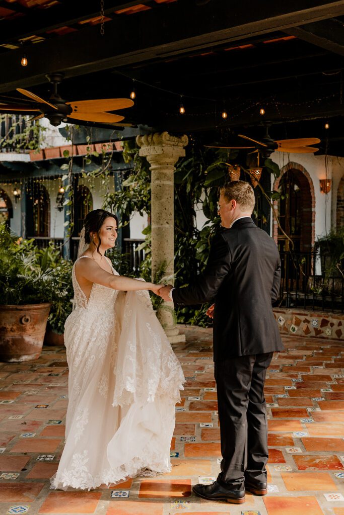 Bride and groom, Michael and Anna, dancing on a tiled terrace surrounded by greenery at Hacienda Siesta Alegre in Puerto Rico.