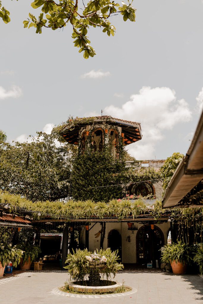 Charming courtyard at Hacienda Siesta Alegre showcasing the rustic architecture with a central fountain and abundant greenery, creating a romantic ambiance.