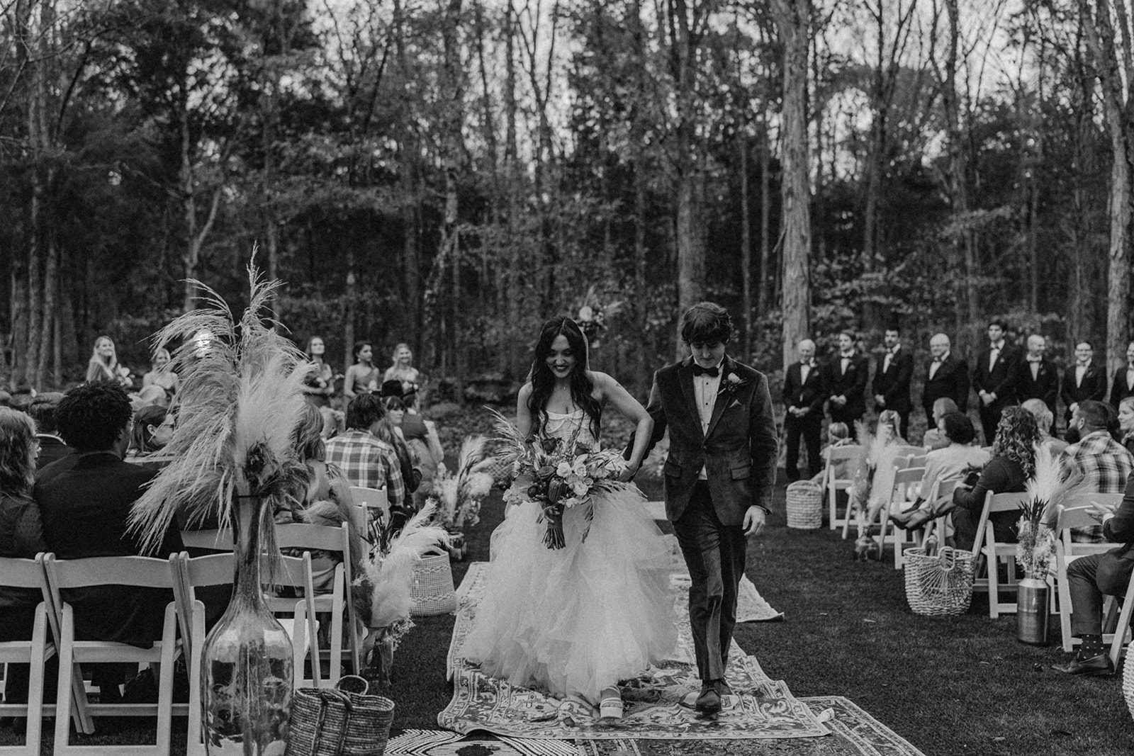 black and white and groom walking down the isle wedding season