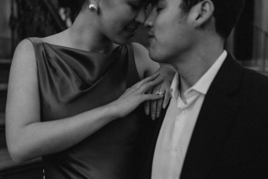 Candid black-and-white photo of engaged couple sharing an intimate moment during their West Village NYC engagement session