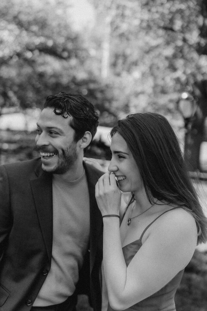 Black and white candid of couple laughing during Central Park engagement session