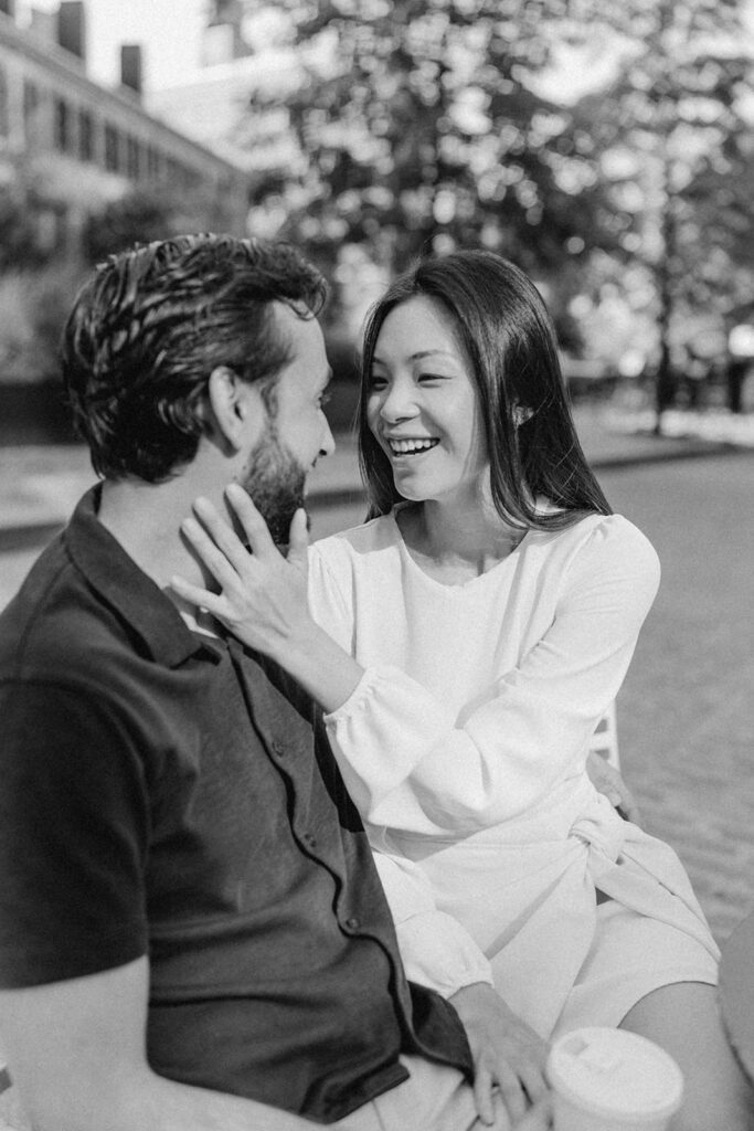 Black-and-white close-up of couple laughing during their Chelsea engagement session

