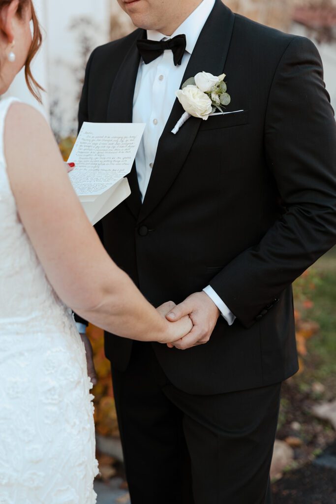Bride reading her vows to the groom during their first look on the lawn at the John James Audubon Center.